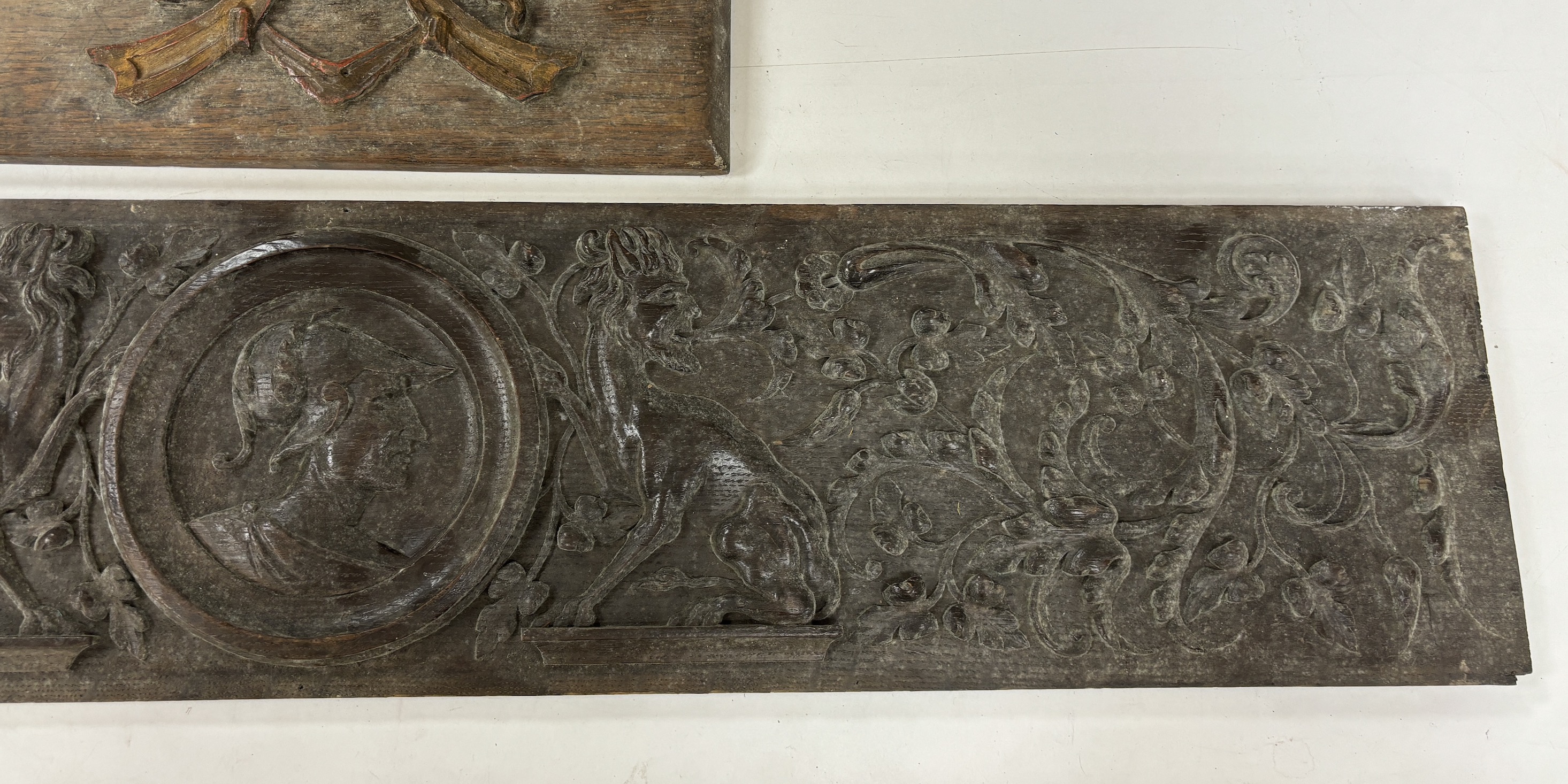 Two 18th century carved oak panels, largest 93cm wide